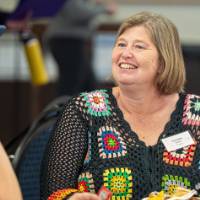 Smiling woman eats lunch